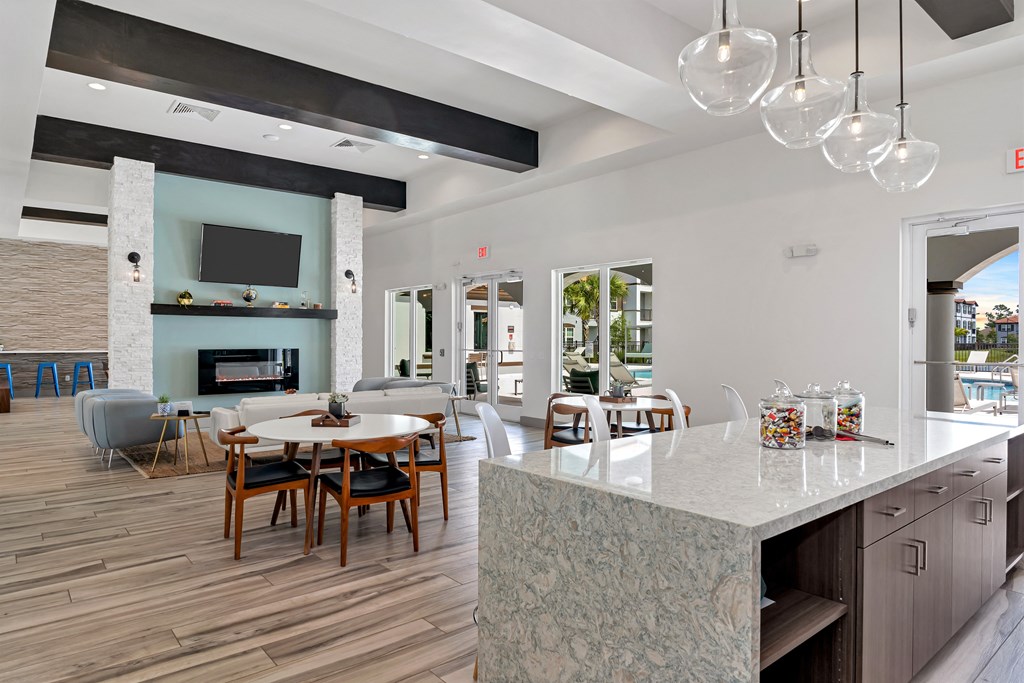 A modern kitchen with a dining table and chairs.