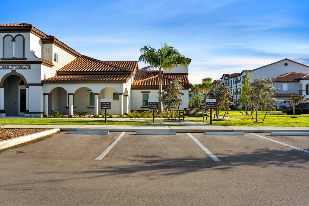 A parking lot in front of a building with a sign that says "MOST Regal Way".