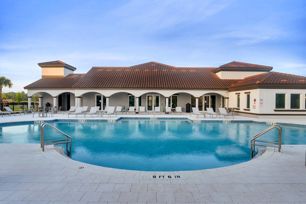A large house with a pool in front.