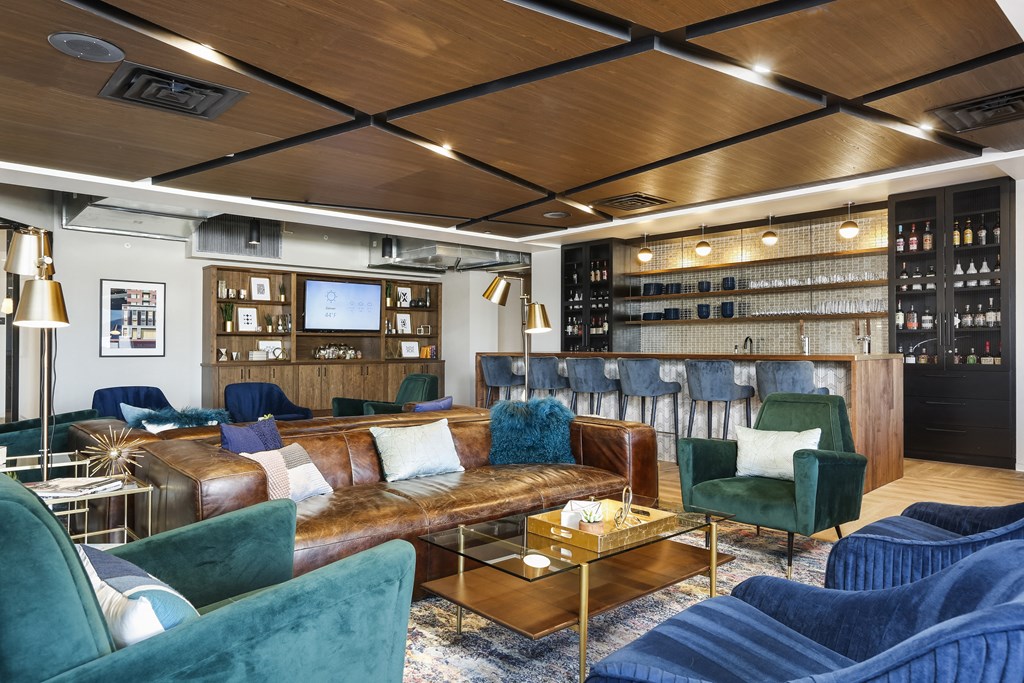 a lounge area with couches and chairs and a bar