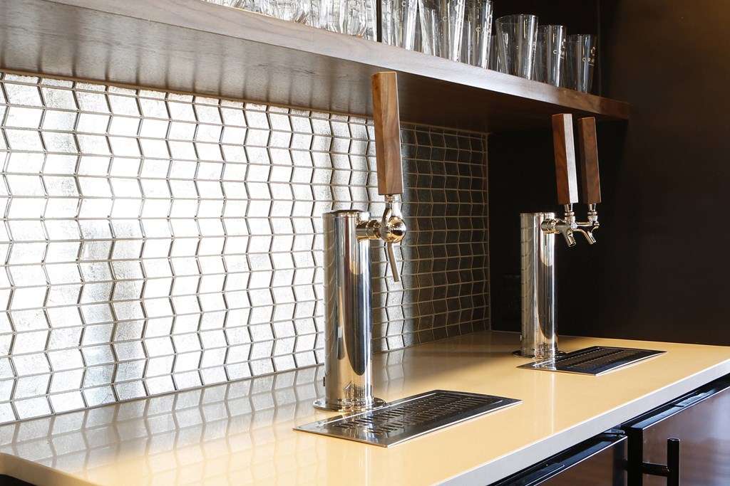 a kitchen with a sink and a tap and a glass window