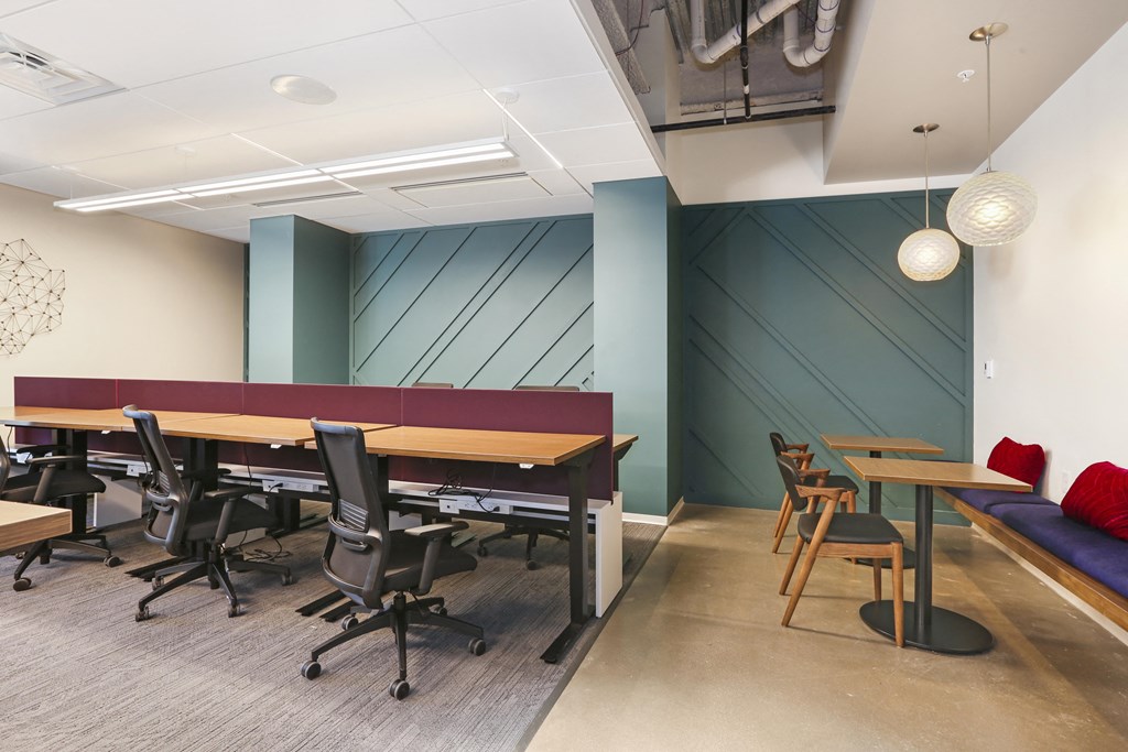 a conference room with tables and chairs and a bench