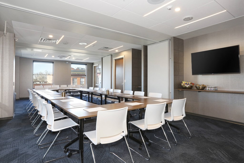 a conference room with a long table and chairs