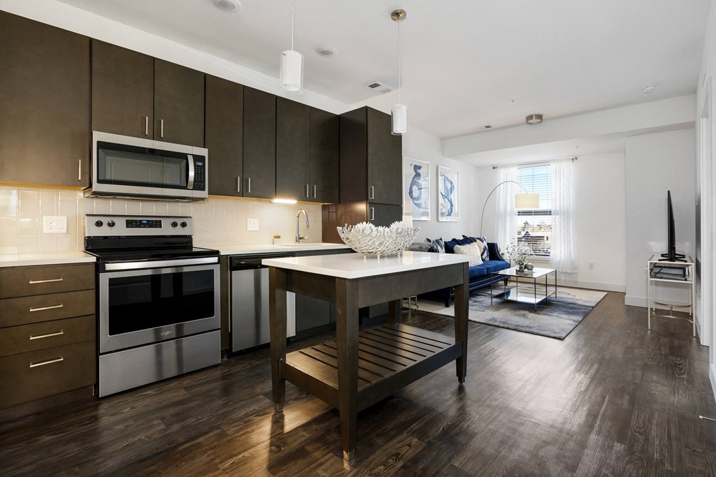 a kitchen with stainless steel appliances and a dining room table