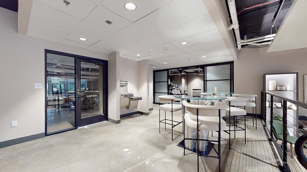 a room with glass doors and tables and chairs