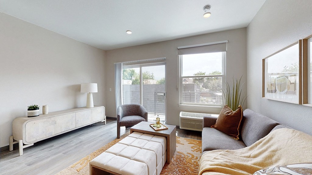 a living room with a couch and a chair and a window
