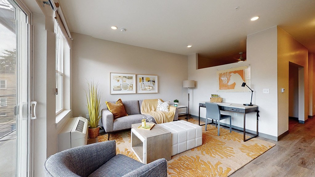 a living room with a couch and a desk