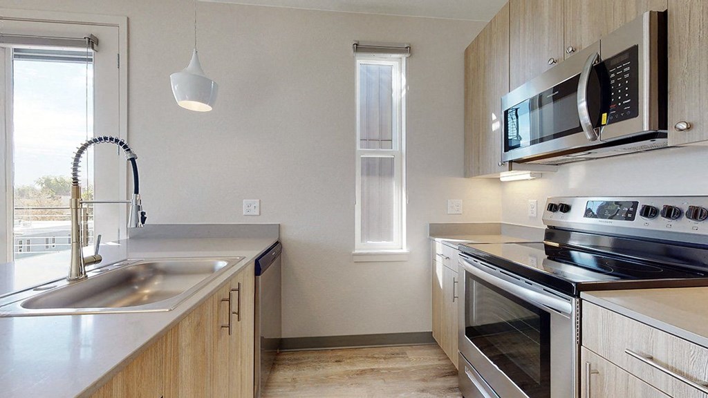 a kitchen with wooden cabinets and stainless steel appliances