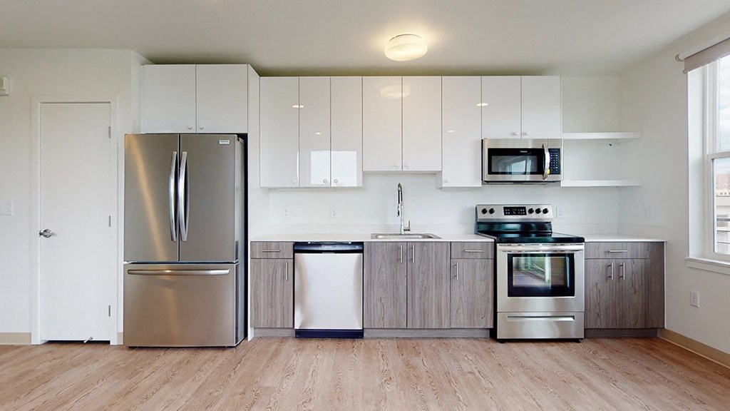a kitchen with stainless steel appliances and white cabinets