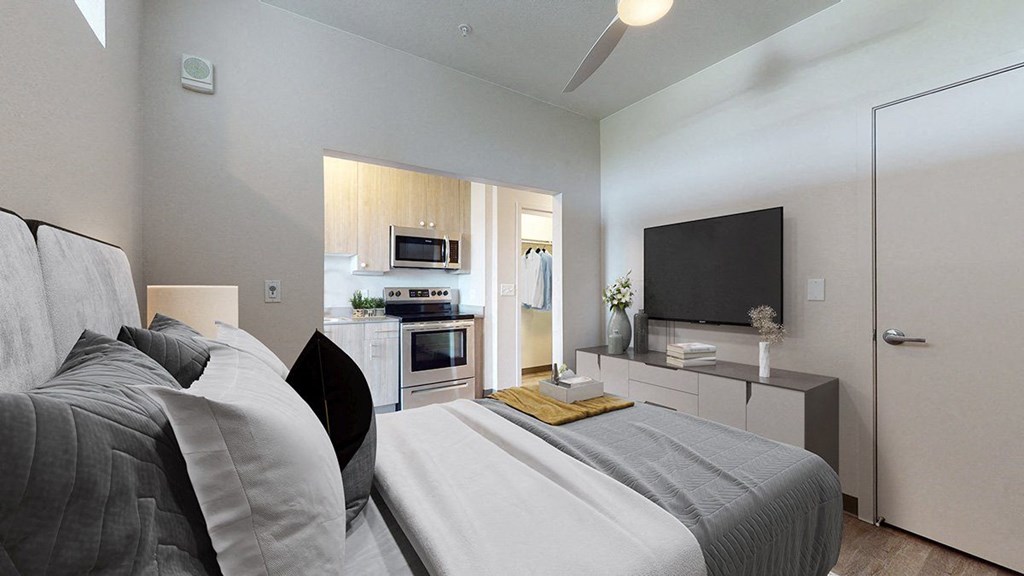 a bedroom with a bed and a television