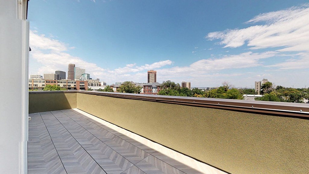 a rooftop terrace with a view of the city