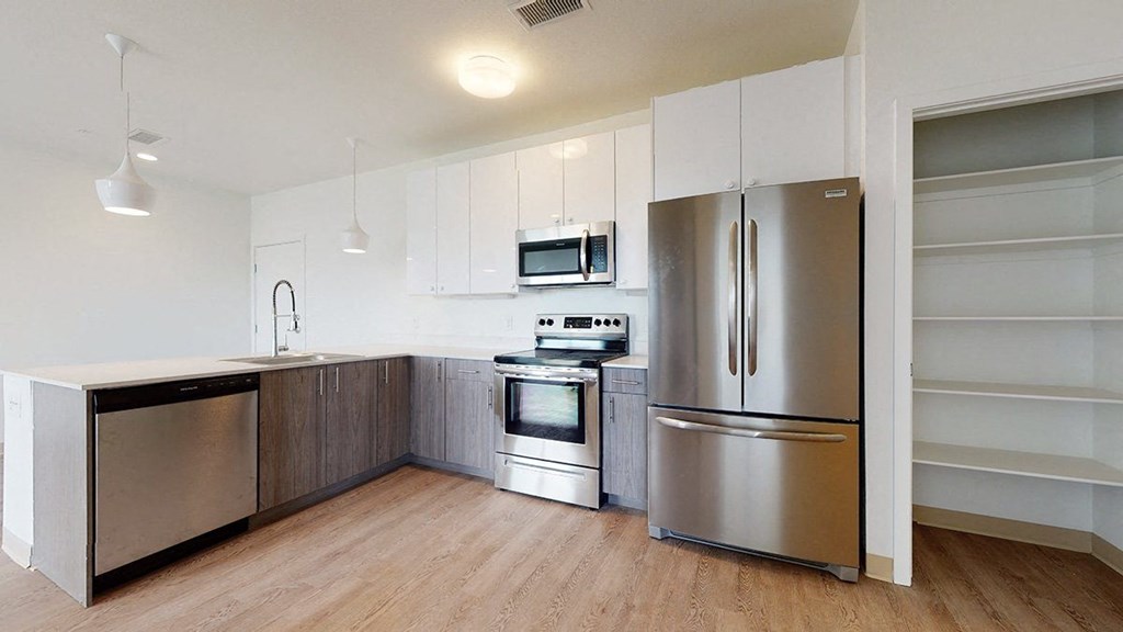 a kitchen with white cabinets and stainless steel appliances