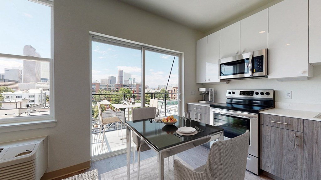 a kitchen with a table and chairs next to a window