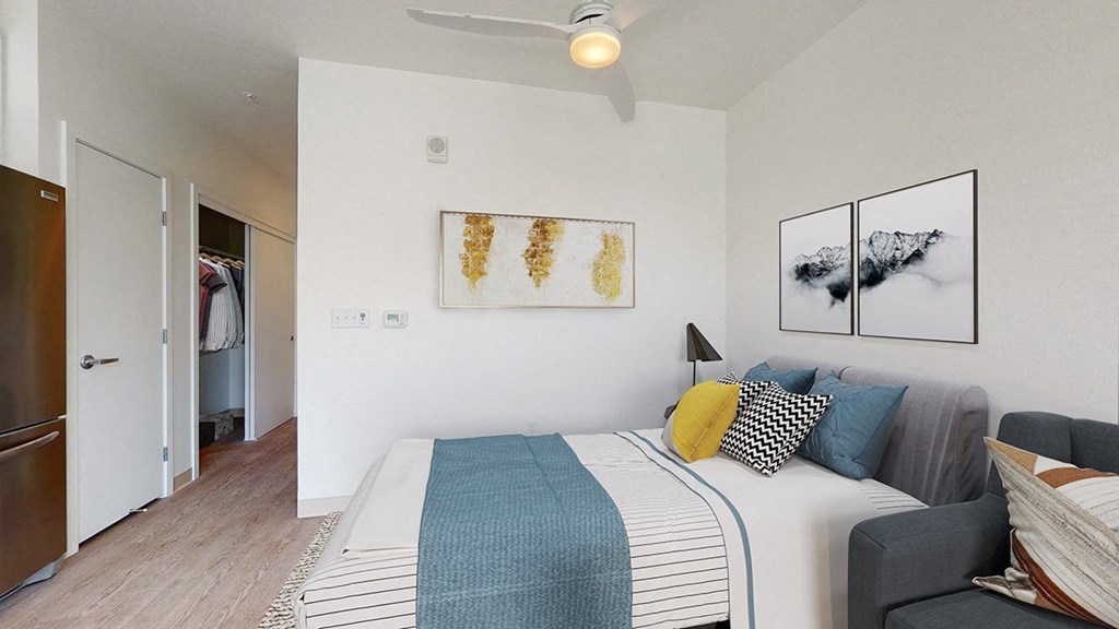 a bedroom with a bed and a ceiling fan