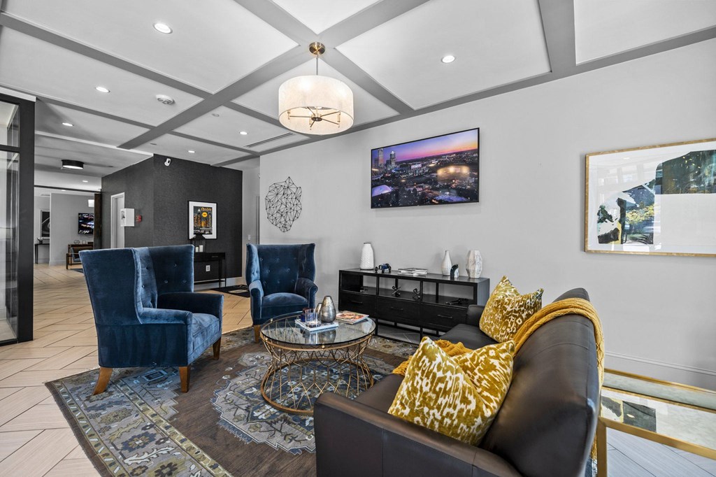 a living room with couches and chairs and a tv
