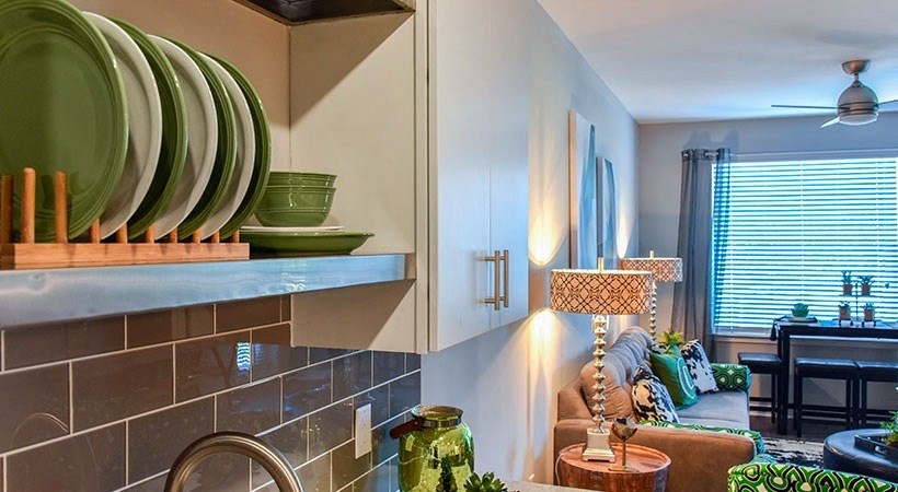 a kitchen with a sink and a living room with a couch