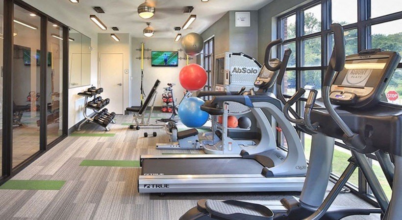 the gym is equipped with cardio equipment and exercise balls