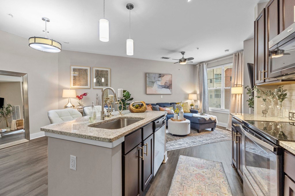 a kitchen with an island and a living room