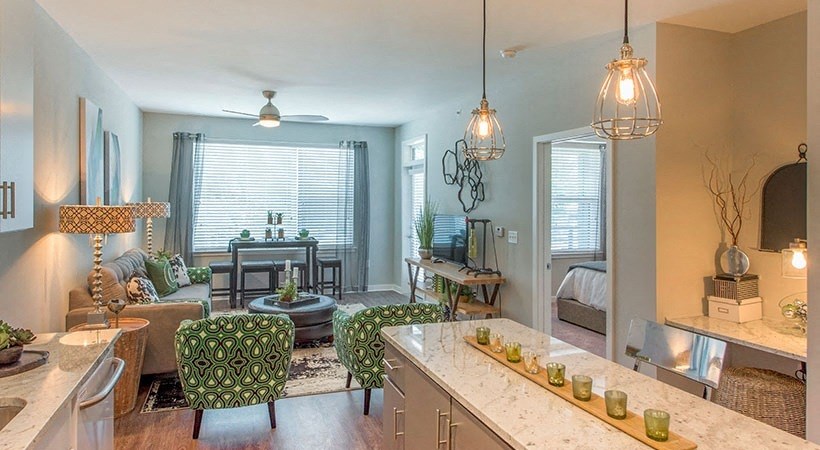 a living room and a kitchen with a table