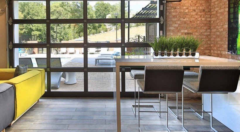 a dining room with a table and chairs in front of a window