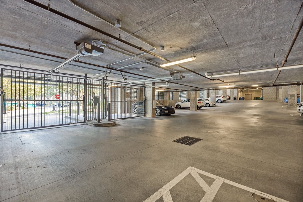 an empty parking garage with cars parked in it