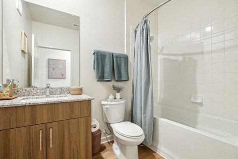 A bathroom with a toilet, sink, and bathtub.