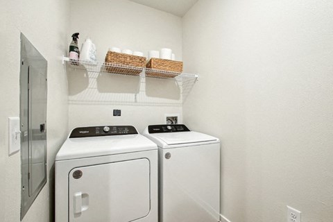 A small laundry room with a washer and dryer.