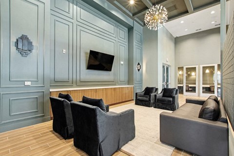 A living room with a grey couch and a television.