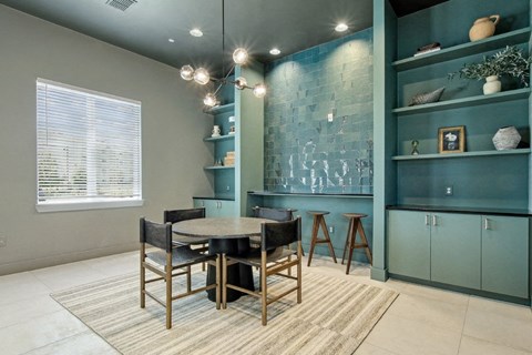 A dining room with a table and chairs.
