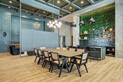 A dining room with a long table and chairs.