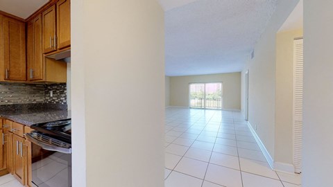 a kitchen with white tile flooring and wooden cabinets