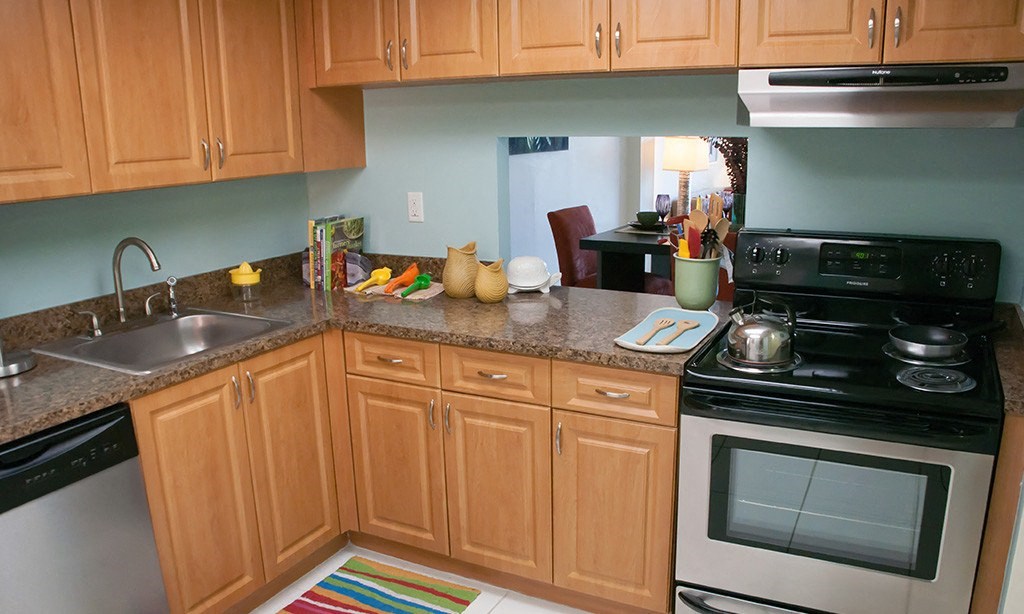 a kitchen with wooden cabinets and a black stove top oven