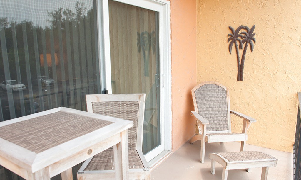 a patio with a table and two chairs