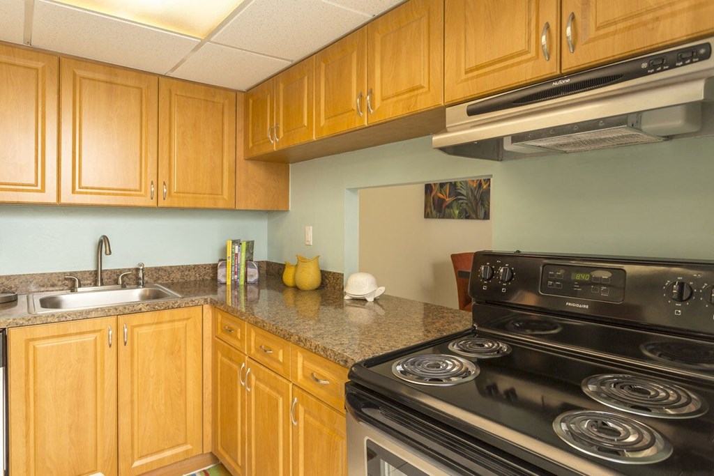 a kitchen with wooden cabinets and granite countertops
