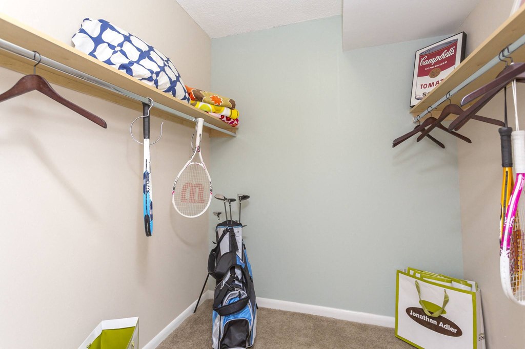 a room with a bike and a shelf with rackets