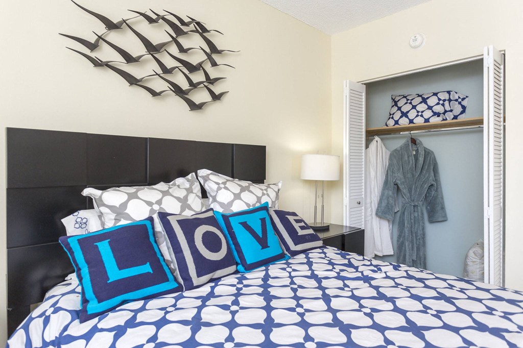 a bedroom with a bed and a closet