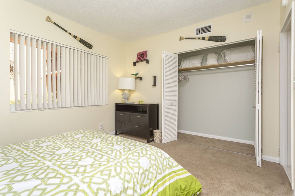 a bedroom with a large bed and a closet with a sliding door