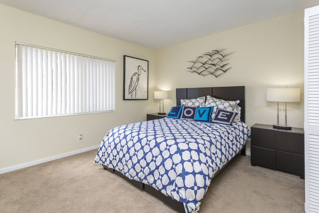 a bedroom with a large bed and two night stands