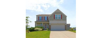 A house with a grey roof and a grey garage door.