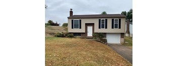 A house with a brown roof and a white garage door.