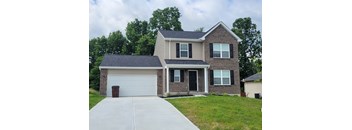 A two-story house with a garage on the left side.