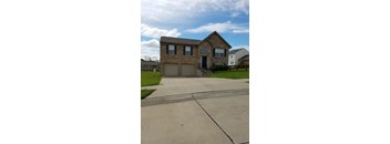 A house with a driveway in front of it.