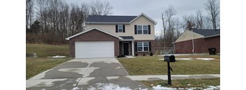 a house with a driveway and a parking meter