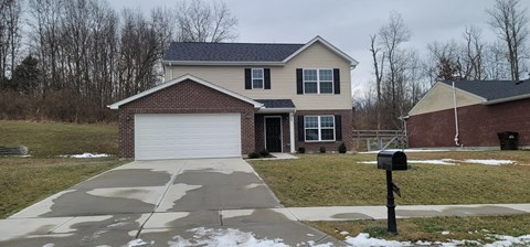 a house with a driveway and a parking meter