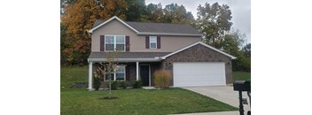 a brown house with a white garage door