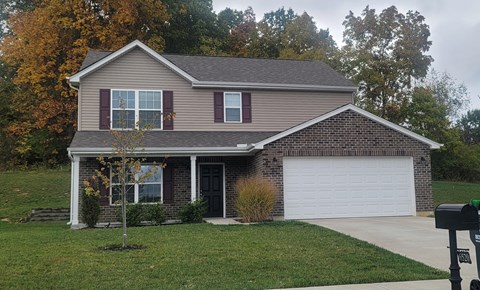 a brown house with a white garage door