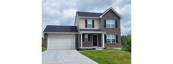 A two-story house with a garage on the left side.