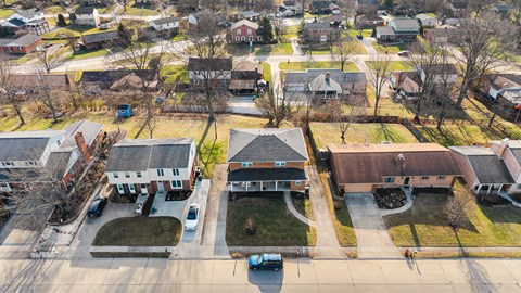 A residential area with houses and cars.