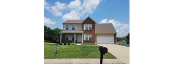 A house with a brown roof and a white garage door.