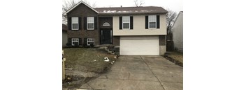 A two-story house with a garage and a driveway.